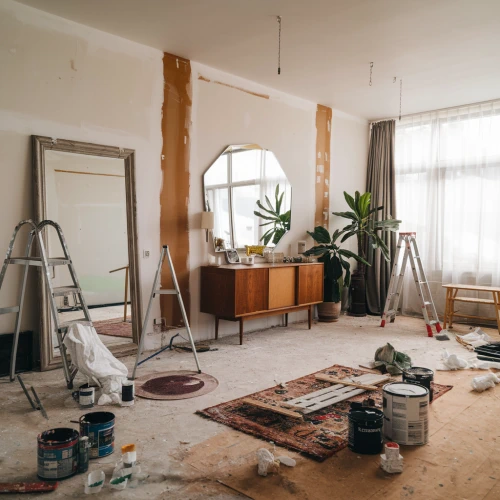Interior Space Feng Shui Renovation. Living room with paint containers, ladder, middle of remodeling